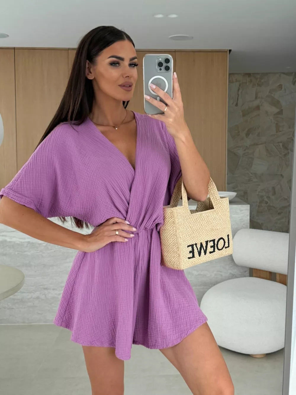 Heliotrope purple V-neck romper with dolman sleeves and a cinched waist detail.