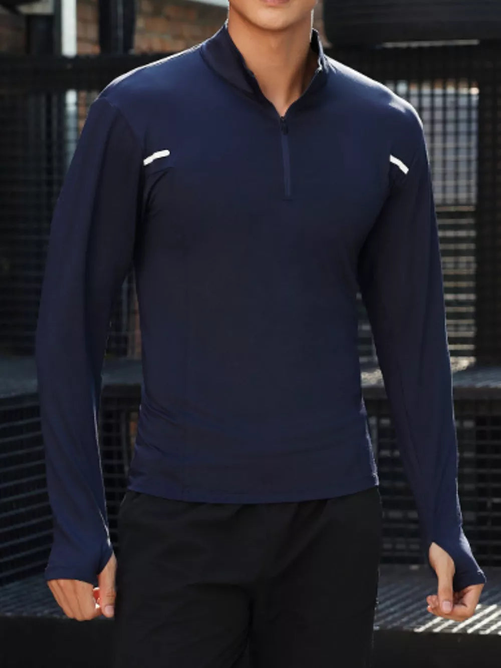 Men's royal blue quarter-zip long sleeve active t-shirt with thumbholes and reflective details.