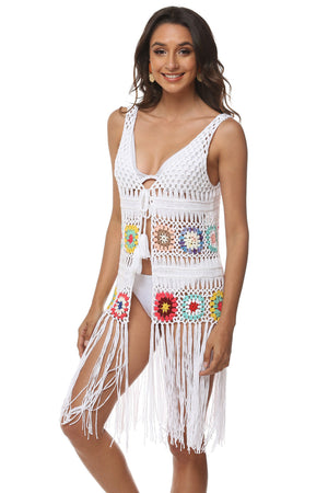 White crochet vest with colorful floral squares and long fringe detail.
