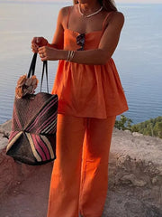Orange square neck cami and wide-leg pants set with spaghetti straps and a flowy top.