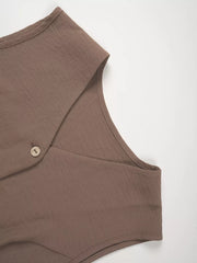 Taupe cropped vest with button detail and wide-leg pants ensemble.