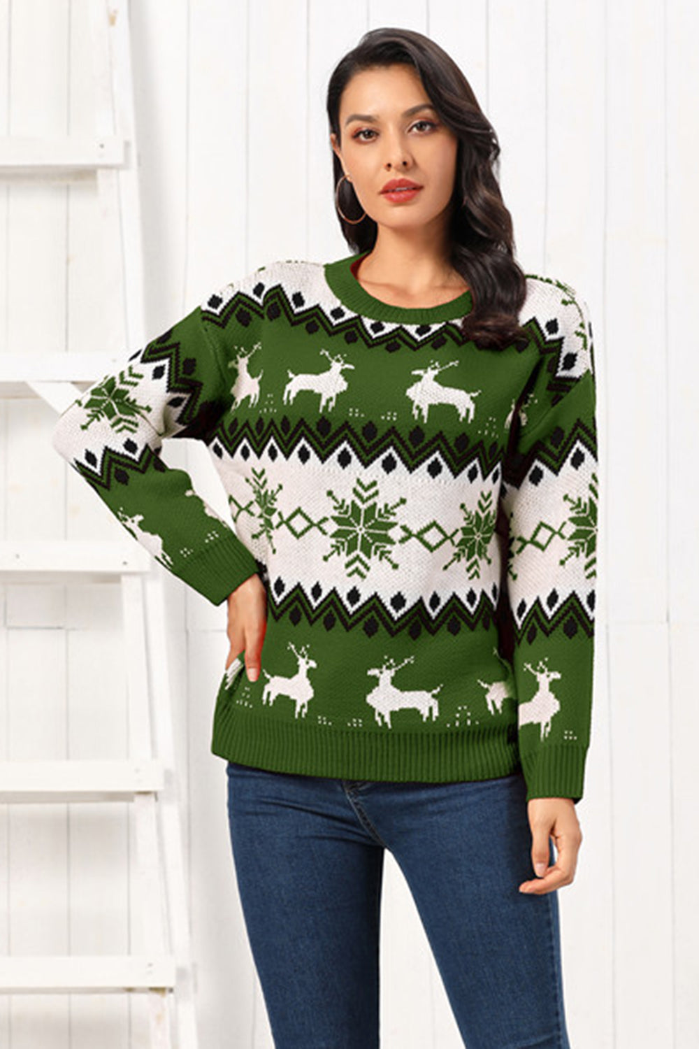 Green acrylic sweater with reindeer and snowflake Fair Isle pattern, crew neck, long sleeves.