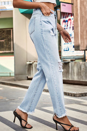 Light wash distressed straight leg jeans with frayed hem and ripped details.