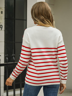 White and red striped acrylic sweater with shoulder buttons and a crew neck.