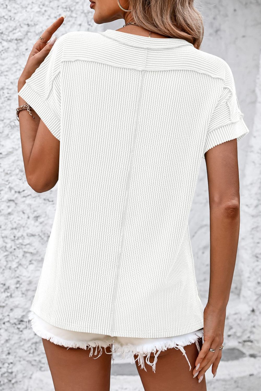 White vertical ribbed tee with split hem and short sleeves, casual chic tunic.