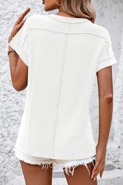White vertical ribbed tee with split hem and short sleeves, casual chic tunic.