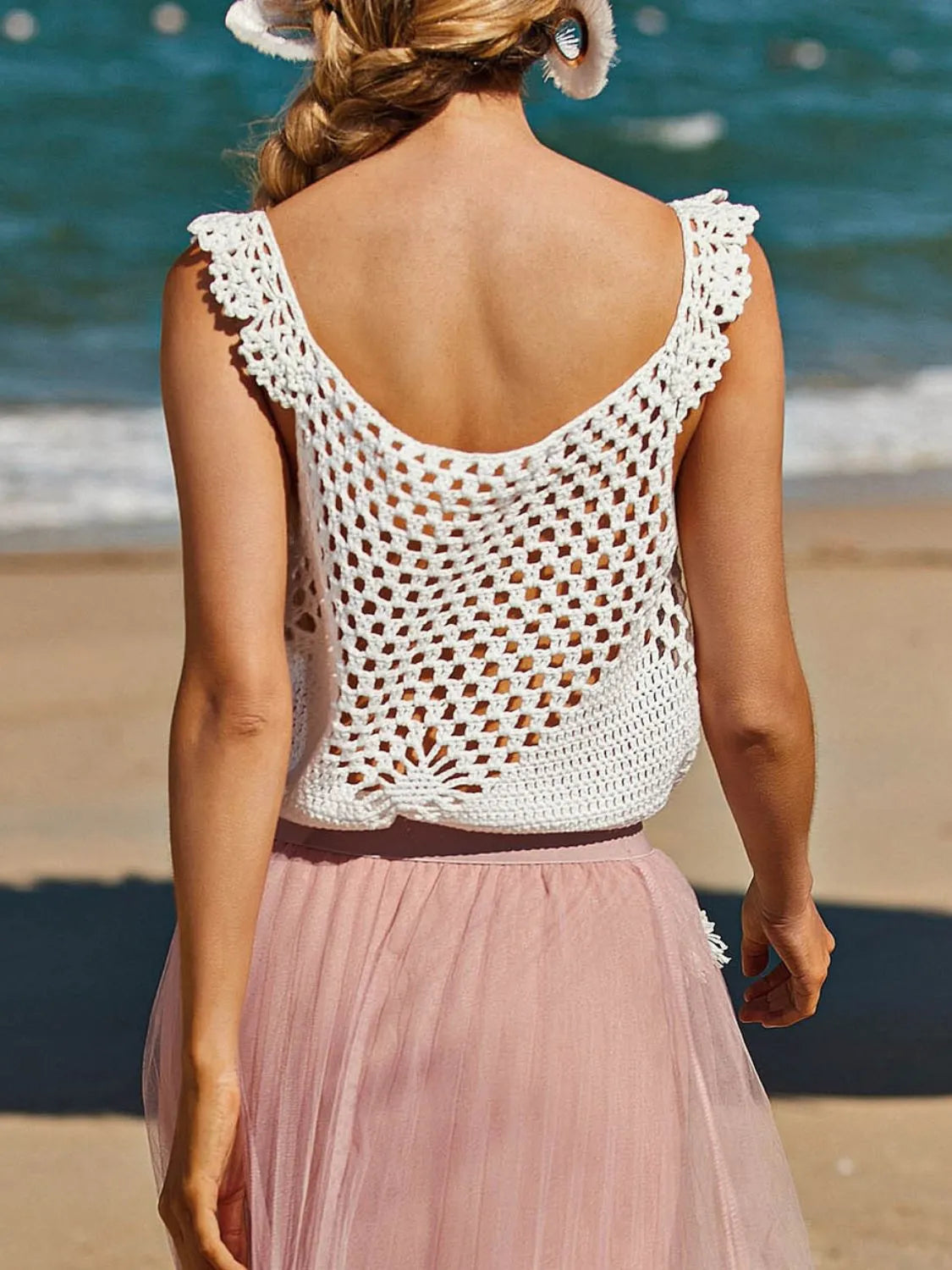 White crochet tank top with ruffled straps and open knit detail.
