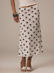 Classic polka dot midi skirt in white with black dots, featuring a sheer overlay and a-line cut.