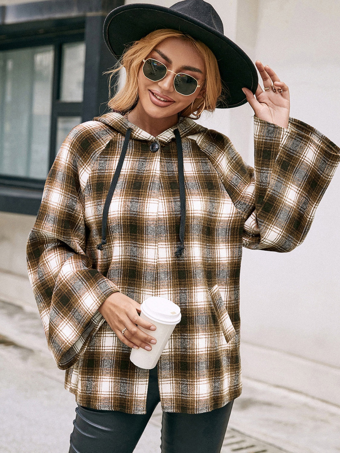 Flared sleeve hooded shacket in camel plaid with drawstring and button detail.