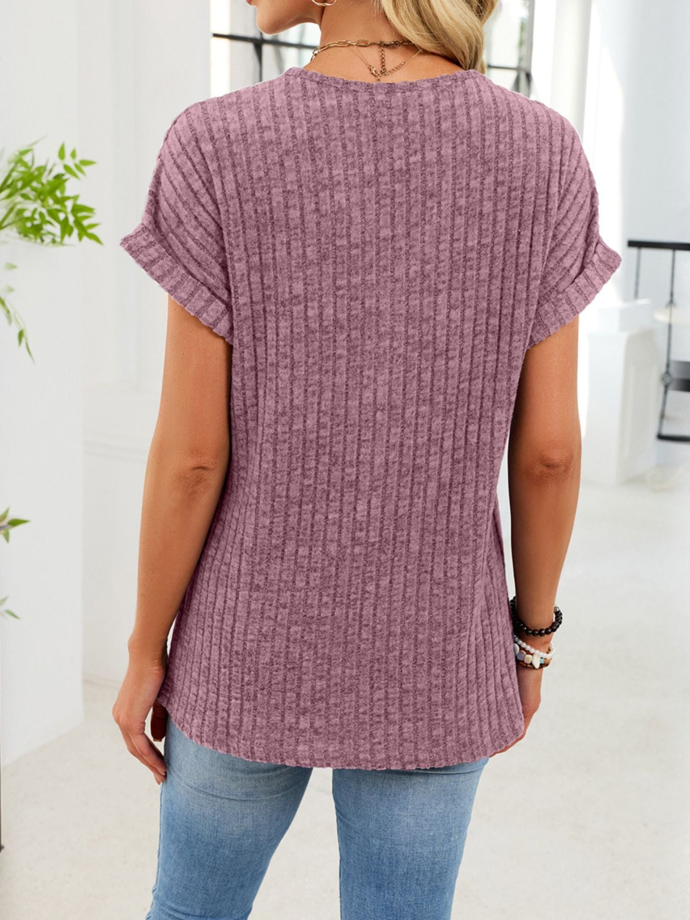 Ribbed knit V-neck t-shirt in burgundy with short cuffed sleeves and button detail.