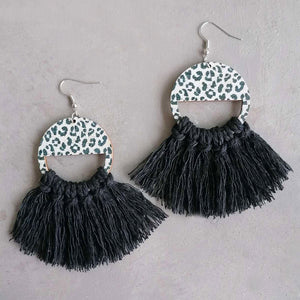 Leopard print tassel earrings with black fringe and half-circle wooden tops.