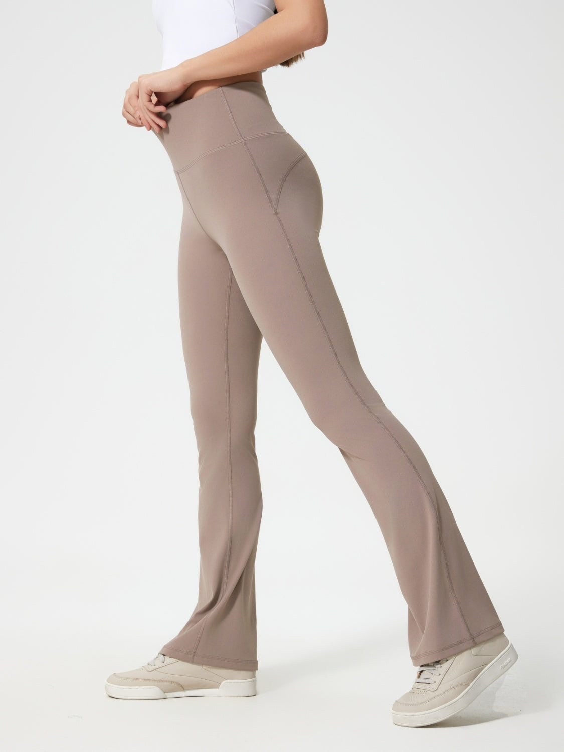 Flared sculpt leggings in mocha with high-rise waist and subtle pocket detail.
