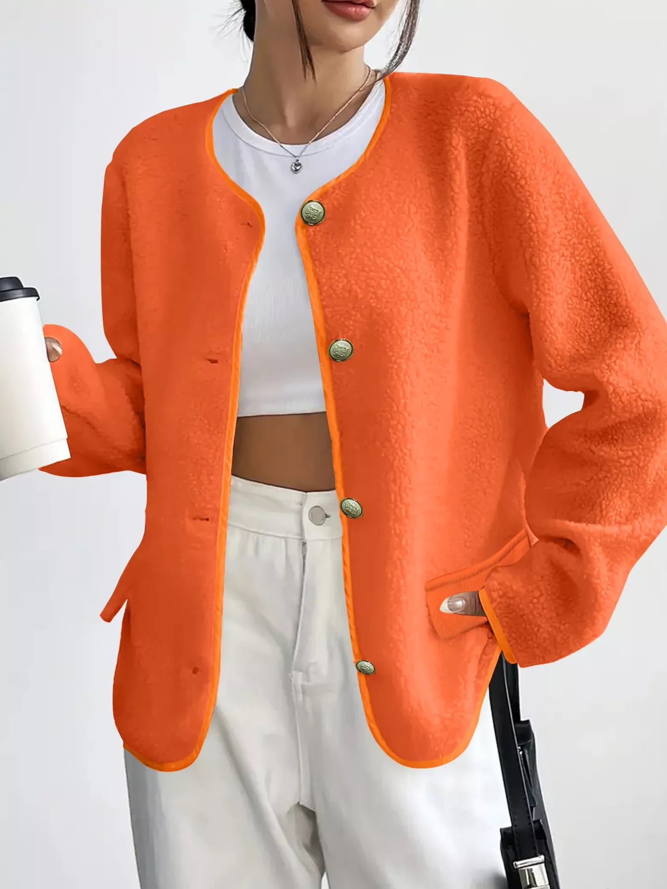 Orange textured button-up fleece jacket with round neckline and contrast trim.