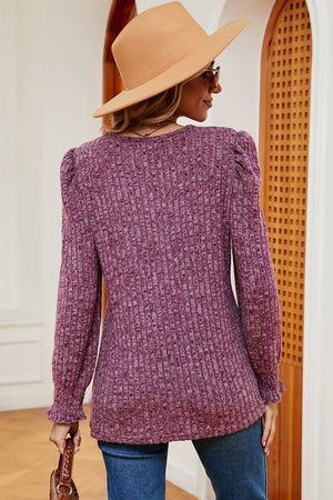 Ribbed knit blouse in Red-Violet with puff sleeves and ruffled cuffs.