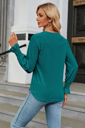 Deep Teal textured V-neck blouse with smocked cuffs and bell sleeves.