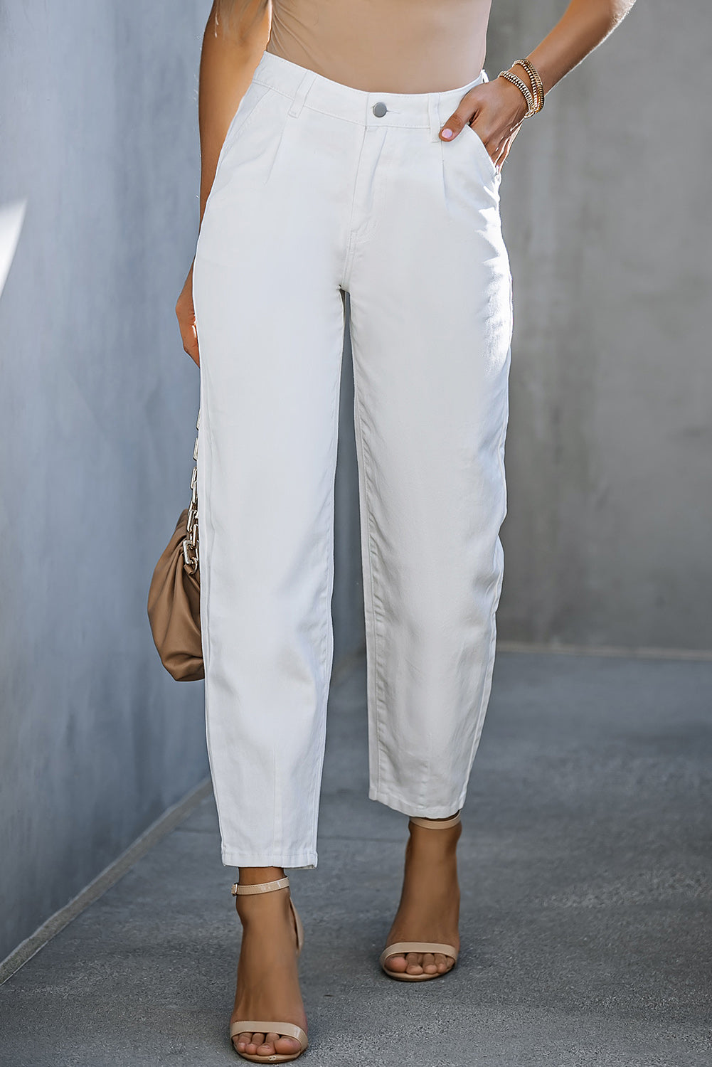White pleated front straight leg jeans with a relaxed fit.