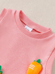 Pink waffle knit baby set with playful 3D carrot appliqués.