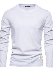 White long sleeve crew-neck tee with textured fabric and a decorative patch detail.