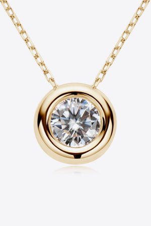 Gold necklace with bezel-set moissanite solitaire pendant and delicate chain.