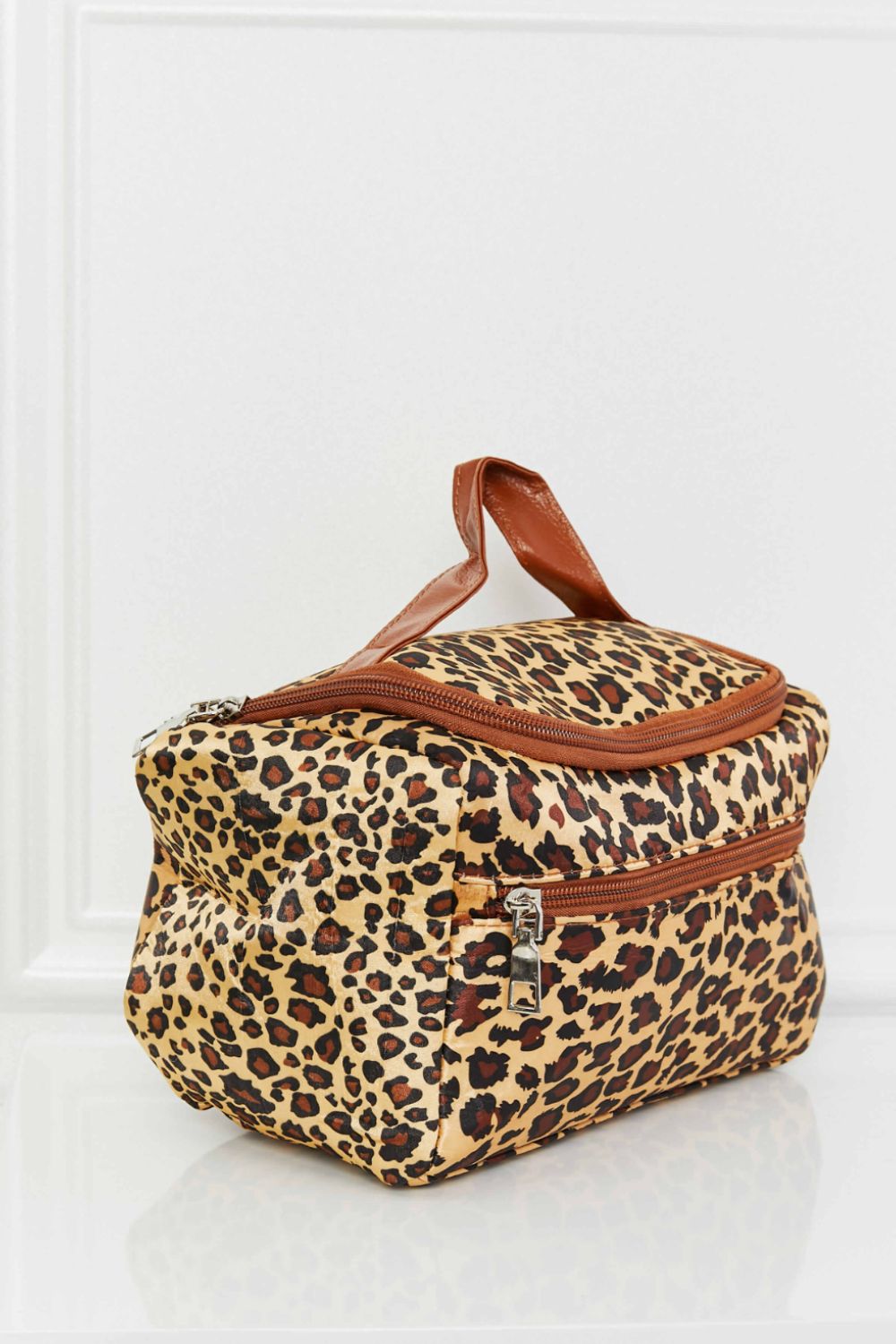 Leopard print travel organizer bag with brown trim and handle.