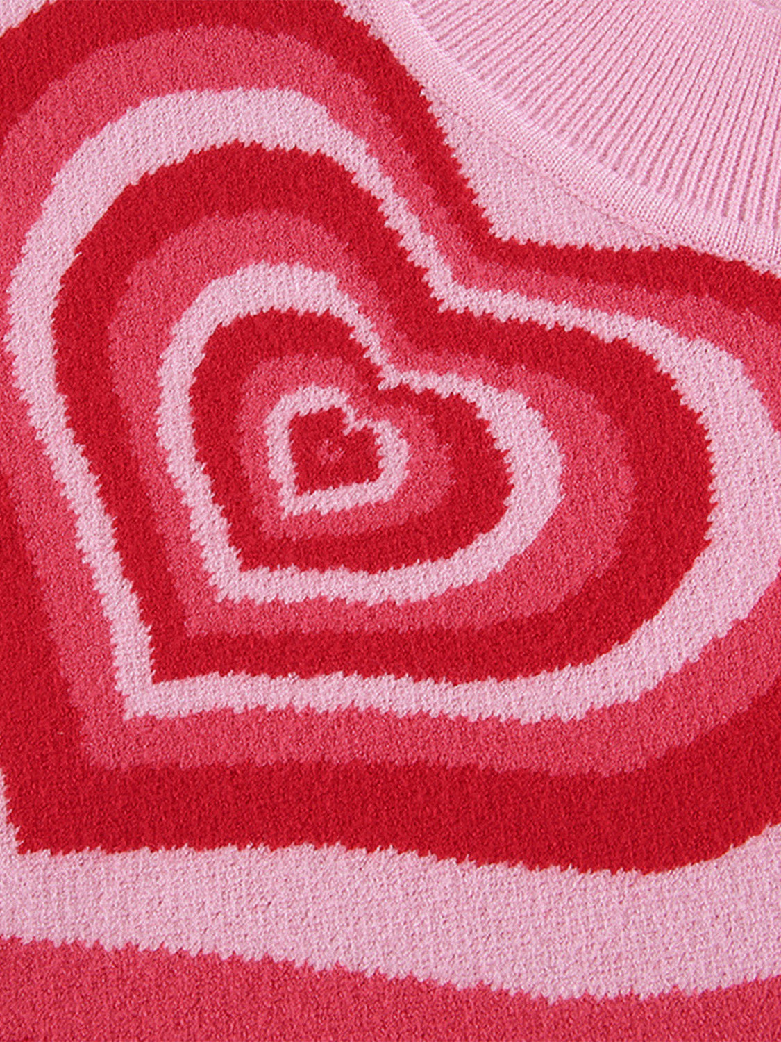 Pink knit tank top with concentric heart intarsia pattern in shades of pink and red.