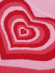 Pink knit tank top with concentric heart intarsia pattern in shades of pink and red.