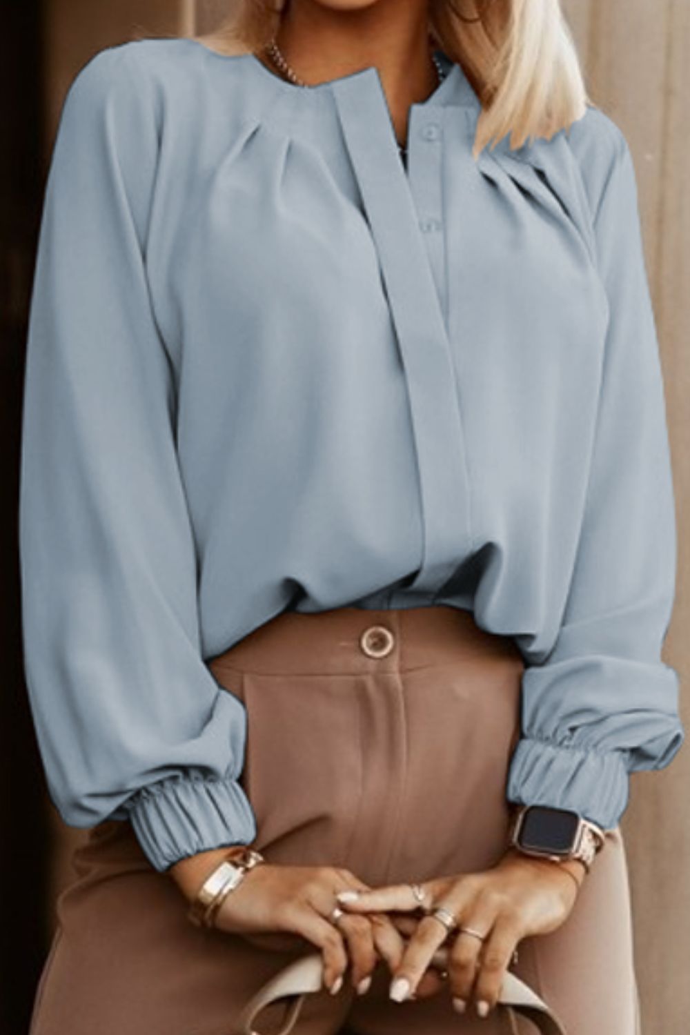 Misty Blue pleated yoke blouse with button detail and elastic cuffs.