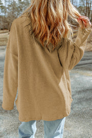 Camel textured shacket with raw-edge detailing and button closure.