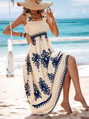 Cream maxi dress with blue floral print, smocked square neck, and ruffled straps.