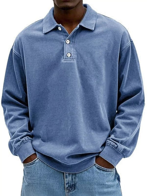 Men's blue vintage washed long sleeve cotton polo shirt with buttoned placket.