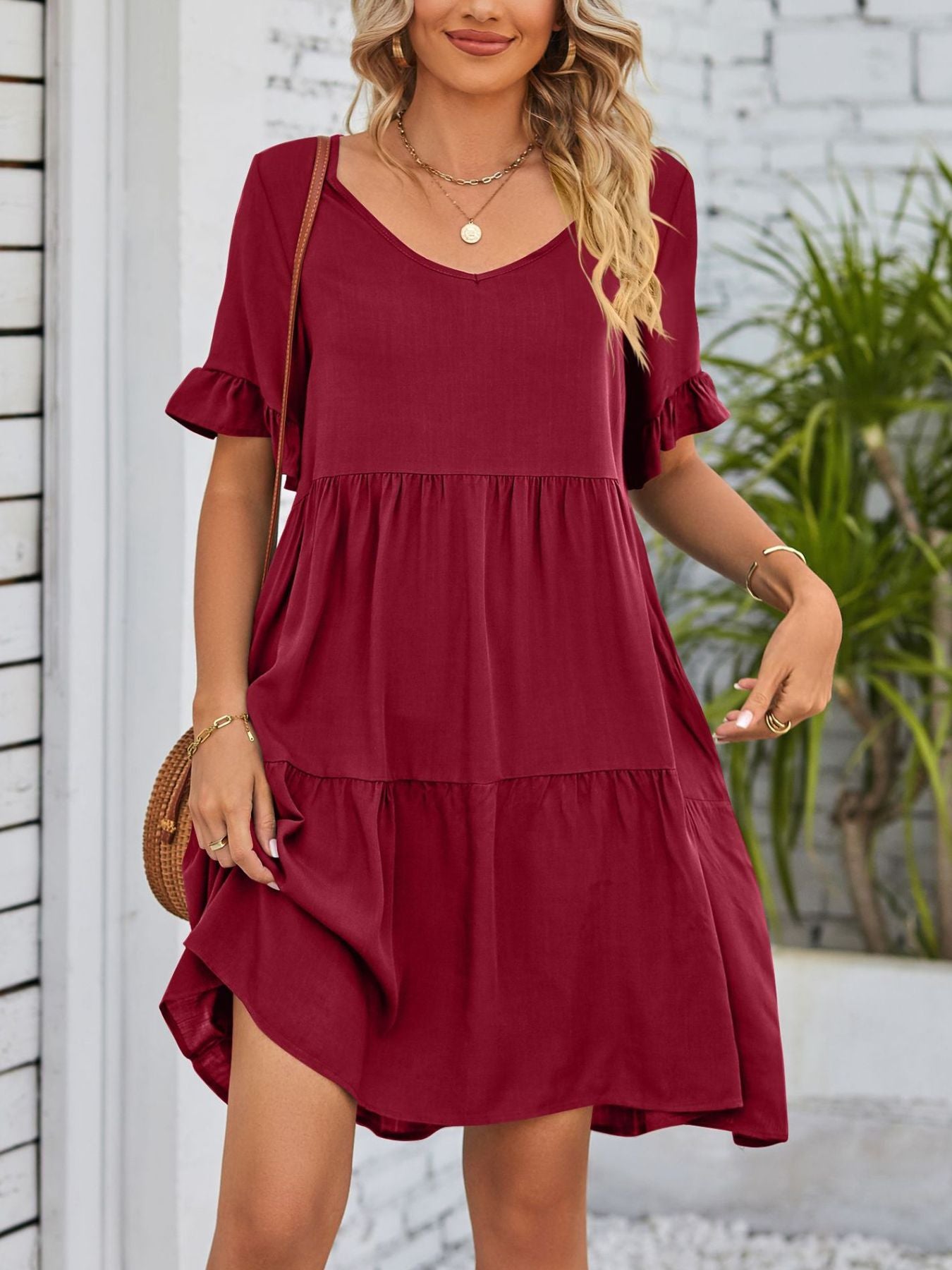 Burgundy ruffled sleeve mini dress with tiered skirt and V-neck.