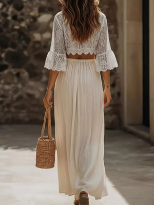 White lace crop top with bell sleeves and a flowing maxi skirt set.