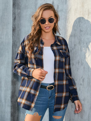 Plaid button-up shirt in dark blue with brown and tan plaid, featuring two chest pockets.