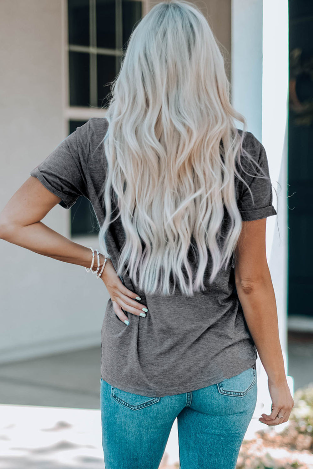 Dark gray t-shirt with short sleeves and a watercolor bow print detail on the back.