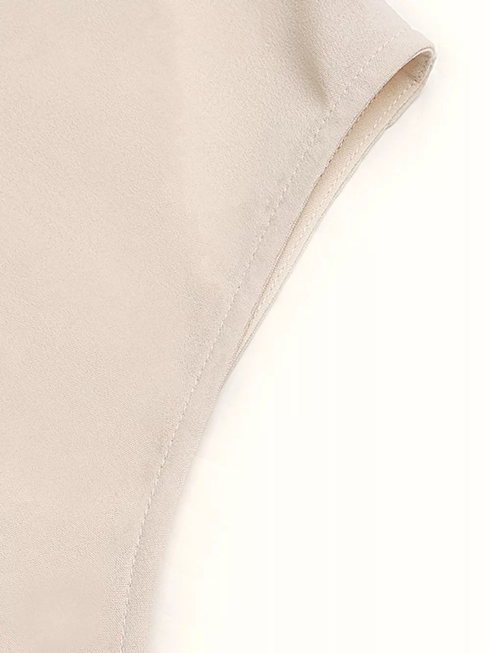 Cream polyester A-line midi dress detail showing clean seams and hem.