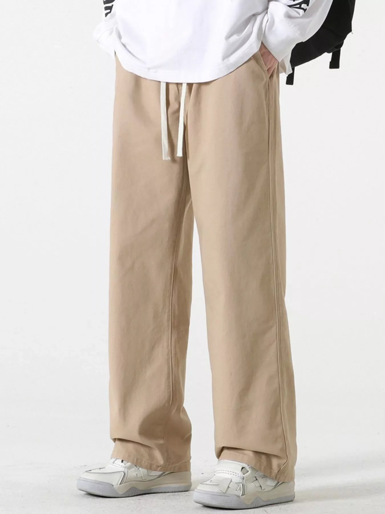 Relaxed fit khaki cotton drawstring pants with a straight leg and side seam detail.