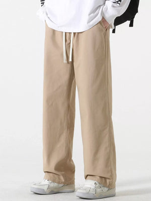Relaxed fit khaki cotton drawstring pants with a straight leg and side seam detail.