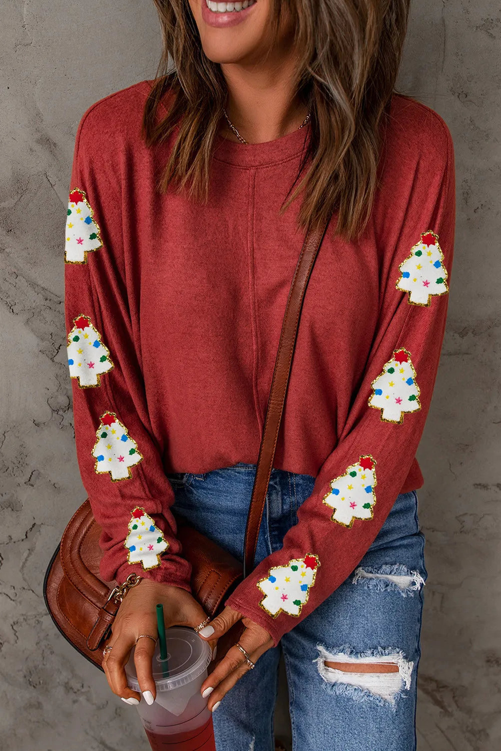 Scarlet crewneck sweater with embellished Christmas trees on sleeves