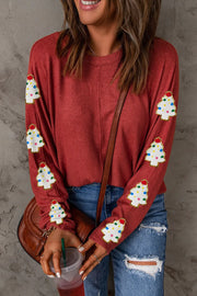 Scarlet crewneck sweater with embellished Christmas trees on sleeves