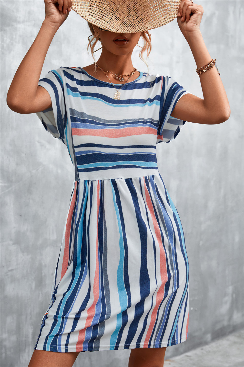 Striped yoke-seam trapeze dress with short sleeves and a gathered waist.