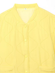 Yellow quilted snap puffer jacket with wave stitching and button front closure.