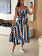 Tie-shoulder midi dress with a colorful zig-zag pattern and adjustable straps.