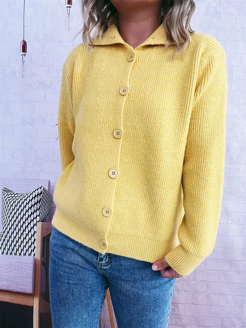Yellow ribbed cardigan with polo collar and button-up front, styled with jeans.