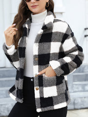 Plaid sherpa overshirt jacket in black and white buffalo check with button front and pockets.