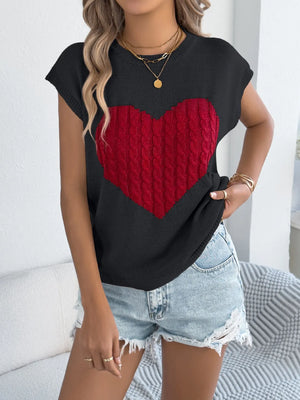 Black cable knit sweater vest with red cable knit heart graphic detail.