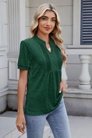 Pleated yoke henley tee in dark green with short sleeves and a V-neck.