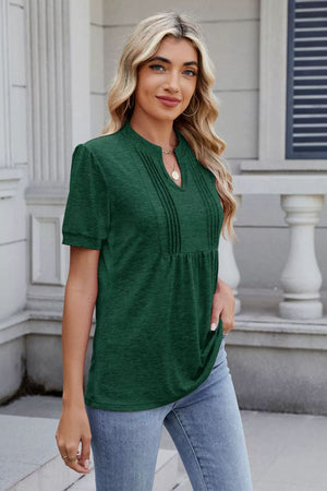 Pleated yoke henley tee in dark green with short sleeves and a V-neck.