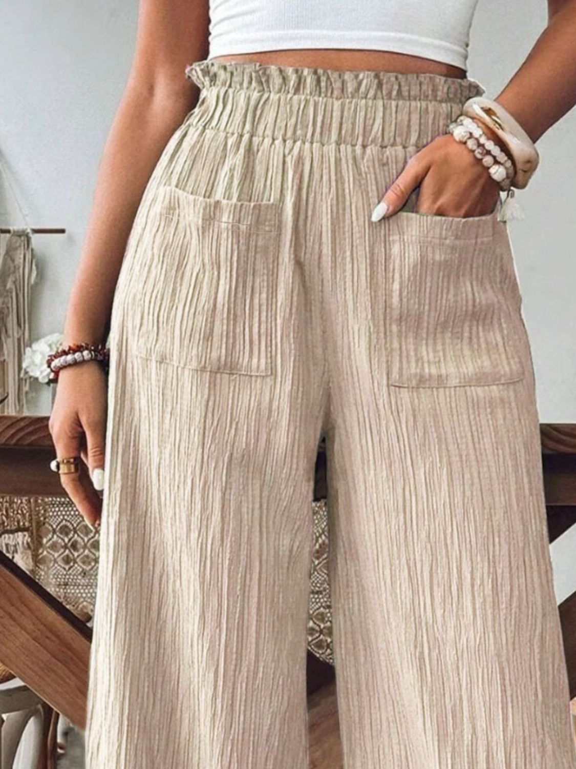 Khaki textured wide-leg palazzo trousers with elastic waist and pockets.
