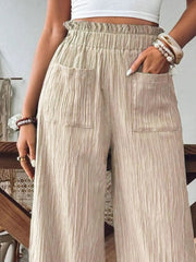 Khaki textured wide-leg palazzo trousers with elastic waist and pockets.