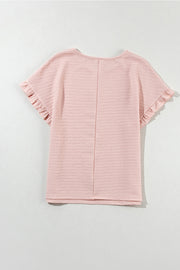 Blush pink textured top with ruffle short sleeves and a round neckline.